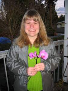Aggie holding Orchid flower