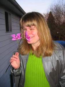 Aggie smelling Orchid flower